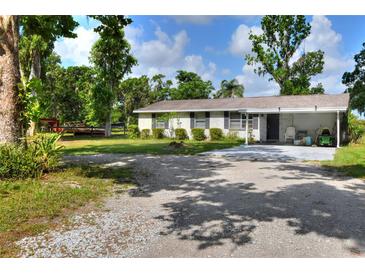 Charming single-story home featuring a large front yard and ample parking space at 12631 Hobson Simmons Rd, Lithia, FL 33547