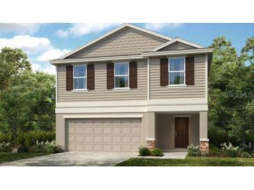 Charming two-story home with neutral siding, shutters and a two car garage at 13245 Tropical Breeze Way, Hudson, FL 34669