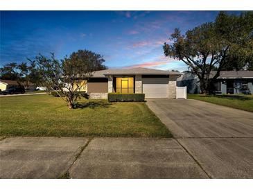 Charming single-story home featuring a well-manicured lawn and a two-car garage at 4085 105Th N Ave, Clearwater, FL 33762