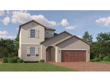 Charming two-story home with a brick driveway and manicured landscaping, perfect for curb appeal at 6611 Active Run, New Port Richey, FL 34653