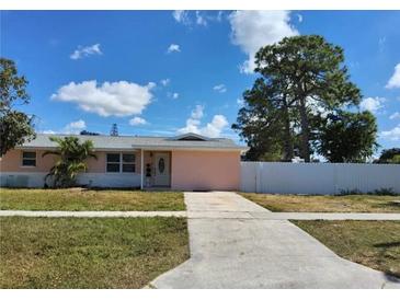 Charming single-story home with a well-maintained lawn, driveway and mature trees at 9161 56 Th, Pinellas Park, FL 33782