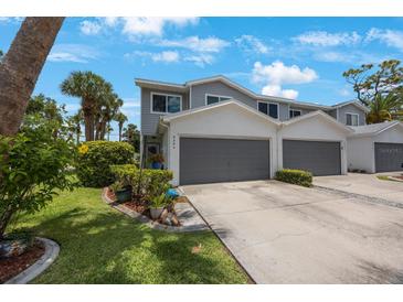 Charming two-story townhome features a two-car garage, well-maintained landscaping, and inviting curb appeal at 9205 Jakes Path, Largo, FL 33771
