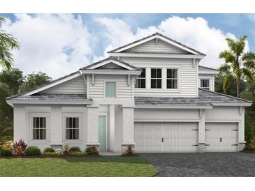 Inviting two-story home boasts a three-car garage, light gray roof, and well-manicured lawn at 10313 Longmeadow Ave, Parrish, FL 34219
