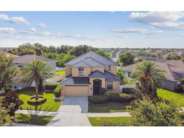 Beautiful two-story home featuring a well-manicured lawn and a black metal roof at 1314 Oak Pond St, Ruskin, FL 33570