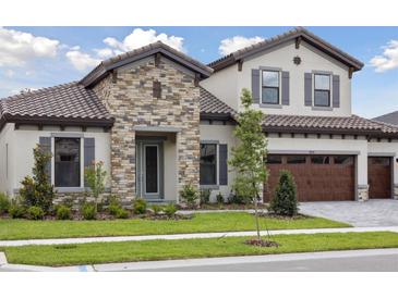 Charming two-story home featuring a stone facade, well-maintained landscaping, and a three-car garage at 14531 Swiss Bridge Dr, Lithia, FL 33547