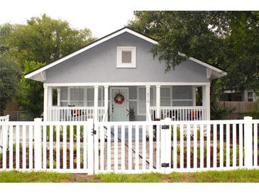Charming bungalow with a white picket fence and welcoming front porch at 1510 Mobile Ave, Tampa, FL 33610