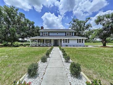 Charming two-story home with a manicured front yard and inviting walkway at 5007 Booth Rd, Plant City, FL 33565