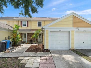 Charming townhome with a one car garage and well maintained front yard at 6114 Oak Cluster Cir, Tampa, FL 33634