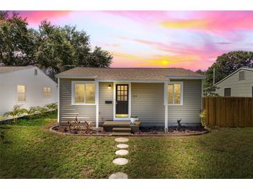 Charming single-story home featuring a well-manicured lawn and inviting front porch with decorative stepping stones at 744 53Rd N Ter, St Petersburg, FL 33703
