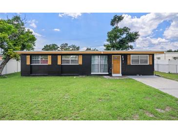 Charming single-story home featuring a well-maintained lawn, freshly painted exterior, and decorative shutters at 1707 Windsor Way, Tampa, FL 33619