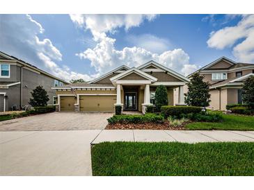 Charming exterior view with a well manicured lawn, a two car garage and neutral tones at 4222 Glade Wood Loop, New Port Richey, FL 34655