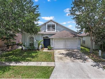Charming single-Gathering home featuring a two-car garage, well-maintained lawn, and mature trees at 509 Delwood Breck St, Ruskin, FL 33570