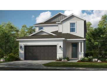 Charming two-story home with a gray roof, a two-car garage, and well-maintained landscaping at 719 Steel Dr, Apollo Beach, FL 33572