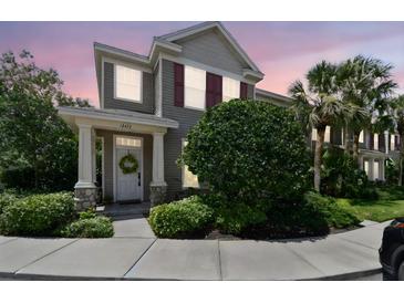 Charming two-story home features a well-manicured lawn and inviting entrance at sunset at 12472 Country White Cir, Tampa, FL 33635