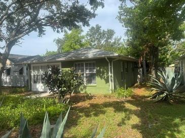 Charming exterior of the single-story home with lots of large trees and greenery at 159 6Th Nw St, Largo, FL 33770