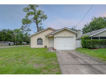 Charming single-Gathering home with a well-maintained lawn and an attached one-car garage at 208 Oakwood Blvd, Oldsmar, FL 34677