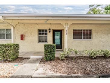Charming condo with stucco exterior, landscaped front, and clearly marked address at 2465 Northside Dr # 605, Clearwater, FL 33761
