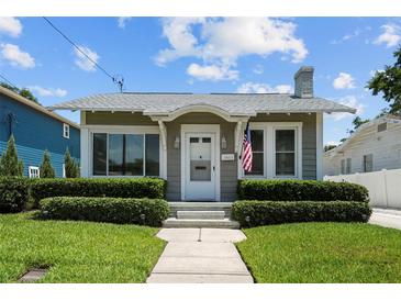 Charming single-story home featuring manicured landscaping, light gray paint, trimmed bushes and a classic design at 2811 W Sitios St, Tampa, FL 33629
