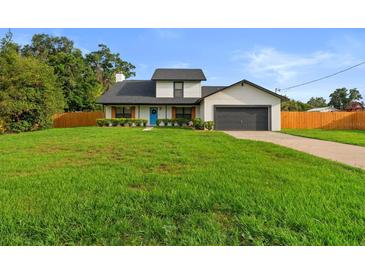 Charming two-story home with a well-manicured lawn, attached garage, and inviting blue front door at 5303 Glen Harwell Rd, Plant City, FL 33566