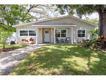 Charming single-story home with a well-manicured lawn and inviting front porch at 615 6Th N Ave, Safety Harbor, FL 34695