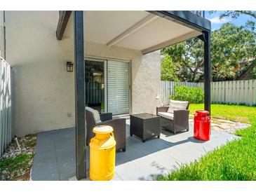 Relaxing patio area with outdoor seating and a view of the green lawn at 1011 S Moody Ave # 11, Tampa, FL 33629