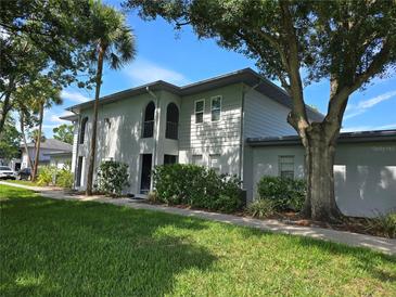 Inviting condo building featuring a well-manicured lawn and mature landscaping, creating a serene and picturesque setting at 10800 Us Highway 19 N # 143, Pinellas Park, FL 33782