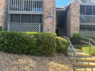 Inviting condo building featuring brick facade, well-maintained landscaping, and clear signage, enhancing curb appeal at 2500 Winding Creek Blvd # B105, Clearwater, FL 33761