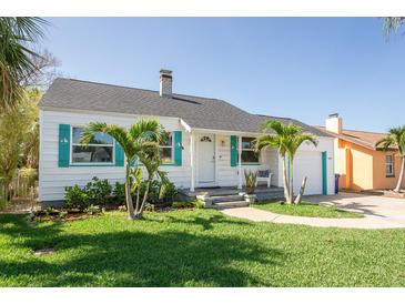 Charming single-story home with a well-manicured lawn, decorative shutters, and a cozy front porch at 434 77Th Ave, St Pete Beach, FL 33706