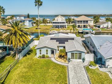 Beautiful single-Gathering home with solar panels, paved driveway, manicured lawn, and nearby waterfront views at 6531 Seaview Blvd, Hudson, FL 34667