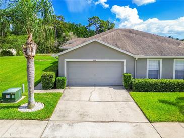 Charming one-story home with a two-car garage, well-manicured lawn, and lush landscaping at 6606 Pullen Ct, Tampa, FL 33625