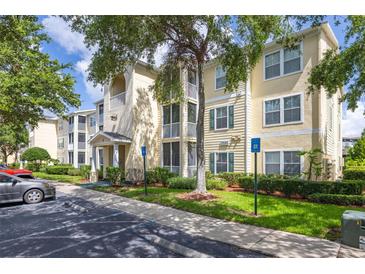 Three-story condo building with balconies, green shrubs, and a parking lot in front at 18439 Bridle Club Dr # 18439, Tampa, FL 33647