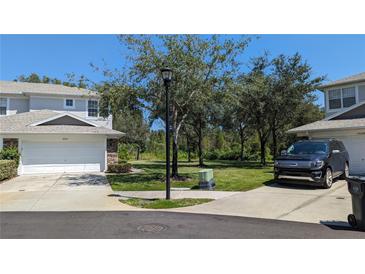 Well-maintained townhome with a two-car garage and a neatly landscaped front yard at 19251 Stone Hedge Dr, Tampa, FL 33647