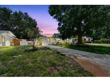 Charming single-story home with a well-maintained lawn and mature trees providing ample shade at 516 Northmoor N Ave, St Petersburg, FL 33702