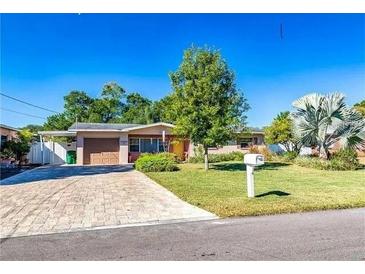 Charming single-story home with a well-maintained lawn and inviting curb appeal on a sunny day at 10218 N Fleetwood Dr, Tampa, FL 33612