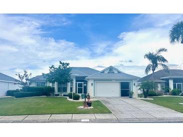 Charming single-story home with lush lawn and well-maintained landscaping at 1607 Alexander Crossing Way, Sun City Center, FL 33573