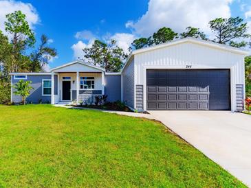 Charming single story home featuring lush lawn, and spacious garage in a lovely suburban setting at 246 Gretna St, Port Charlotte, FL 33954