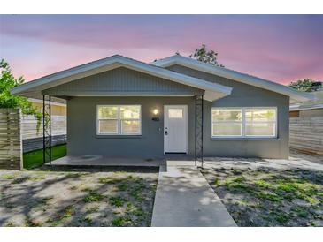 Charming home featuring updated gray paint, new windows, and inviting curb appeal with sidewalk leading to the front door at 483 32Nd N Ave, St Petersburg, FL 33704
