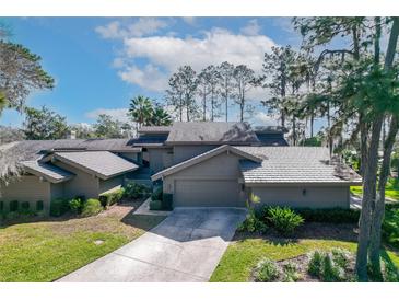 Stunning exterior view of the property featuring lush landscaping and a well-maintained driveway at 5340 Cobblestone Ct, Wesley Chapel, FL 33543
