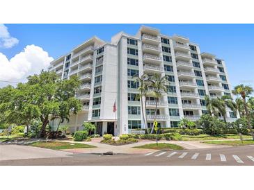 Stunning exterior view of Harbour Hill, featuring balconies, lush landscaping, and direct street access at 700 Beach Ne Dr # 606, St Petersburg, FL 33701