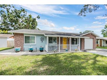Charming single-story home with a sunny yellow door and stone accents at 9056 108Th Ave, Seminole, FL 33777