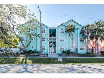 Charming turquoise condo building with lush landscaping and a welcoming entrance at 3002 W Cleveland St # B9, Tampa, FL 33609