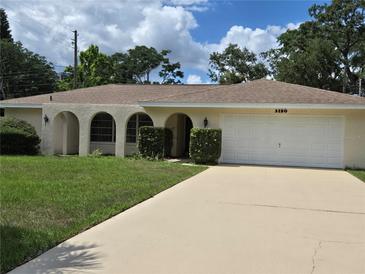 Charming single-story home with arched entryway, two-car garage, and well-maintained lawn at 3150 San Jose St, Clearwater, FL 33759