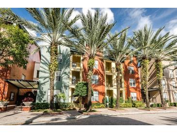 Beautiful building facade with palm trees, colorful paint, multiple windows, and balcony views at 504 S Armenia Ave # 1329B, Tampa, FL 33609