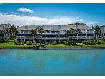 Waterfront condo complex features multiple units with private balconies and lush landscaping at 12132 Capri S Cir, Treasure Island, FL 33706