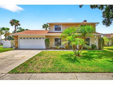 Charming two-story home with a well-manicured lawn, stone accents and a two-car garage at 15925 Marshfield Dr, Tampa, FL 33624