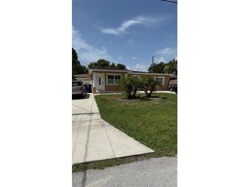 Charming single-story home with well-maintained lawn and landscaping at 2120 W Virginia Ave, Tampa, FL 33607