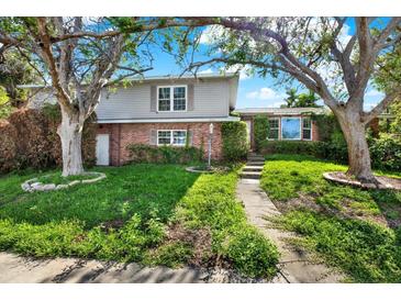 Charming two-story home with brick and siding exterior and lush landscaping at 4173 85Th N St, St Petersburg, FL 33709