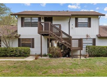Charming two-story home with wooden staircase and well-maintained lawn at 4945 91St N Ave # 30, Pinellas Park, FL 33782