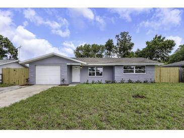 Charming single-story home with a well-manicured lawn, fresh exterior paint, and an attached one-car garage at 7625 Marechal Ave, Port Richey, FL 34668