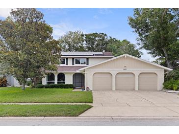 Charming two-story home with a well-manicured lawn and a three-car garage at 10053 W Bay St, Seminole, FL 33776